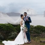 Couple posing for wedding pictures on a rainy day in San Francisco
