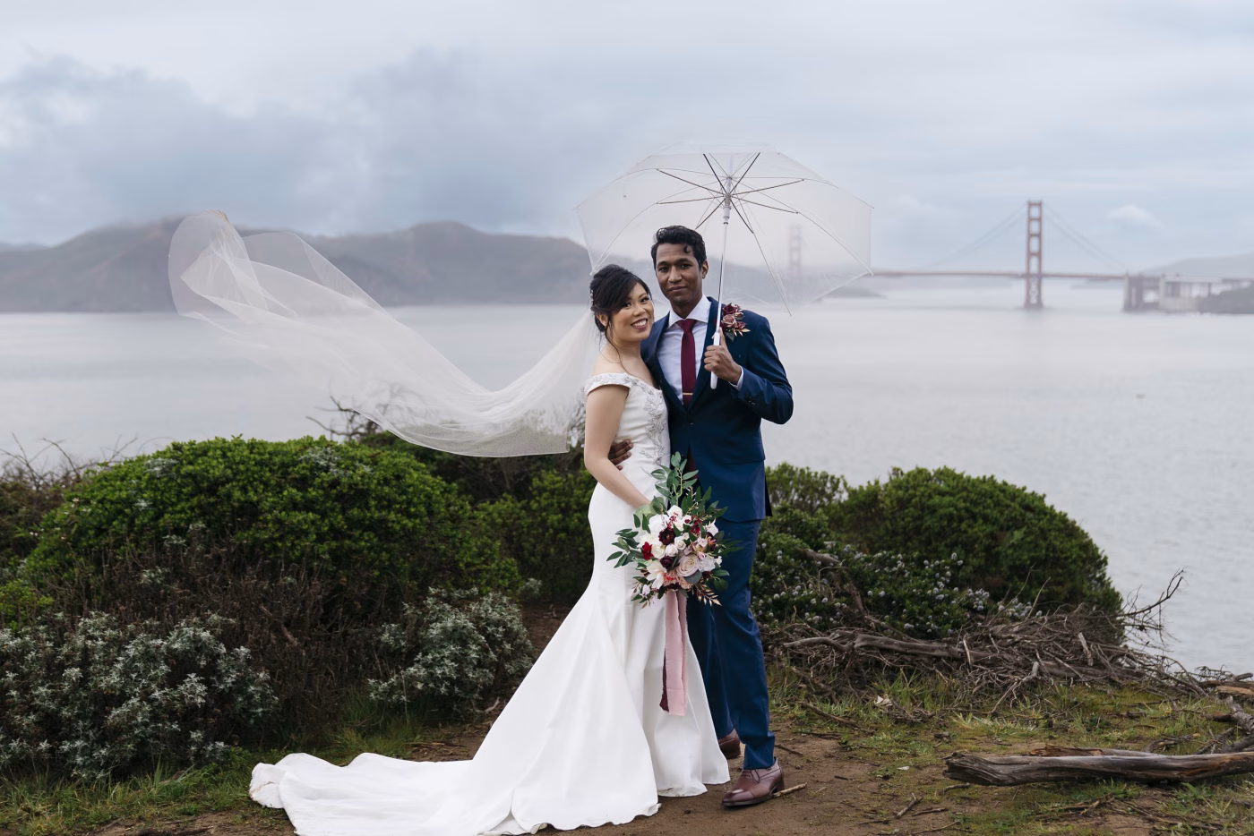 Couple posing for wedding pictures on a rainy day in San Francisco