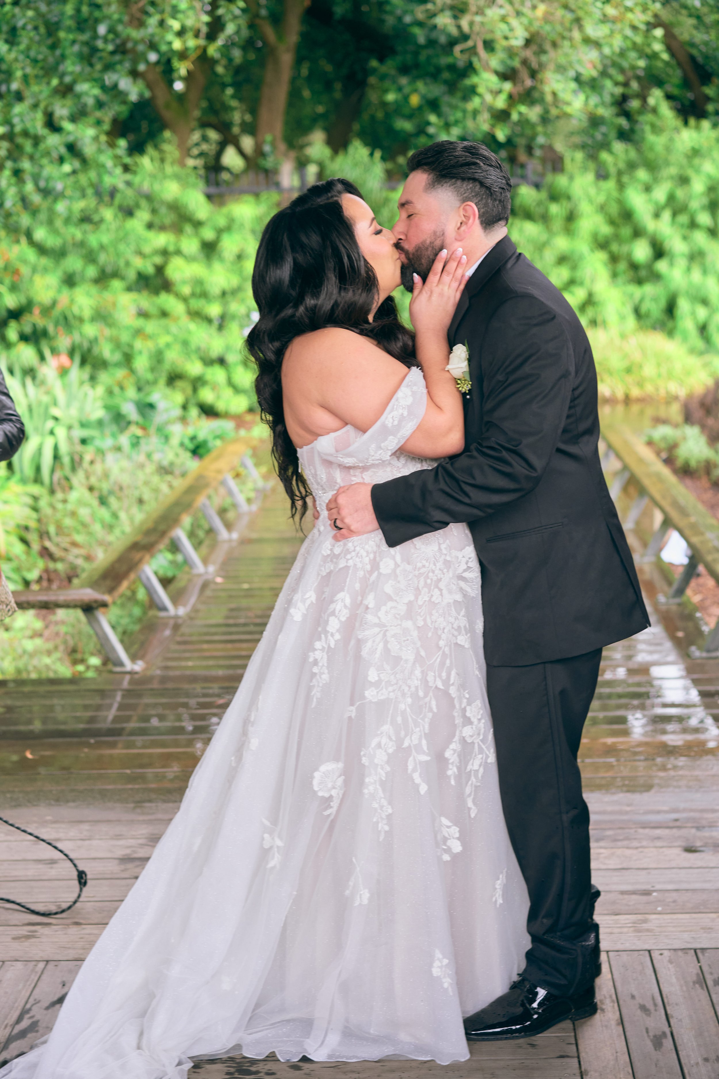Bride and groom kiss on the pavilion at San Francisco Botanical Gardens.