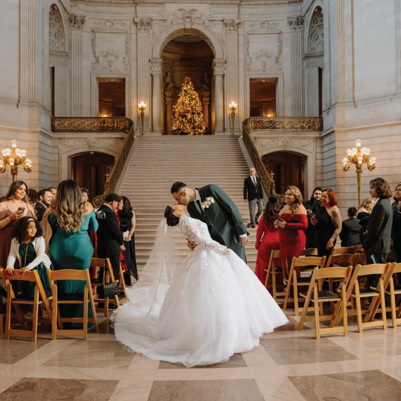 Newly Weds in San Francisco sharing their first kiss in front of the staircase