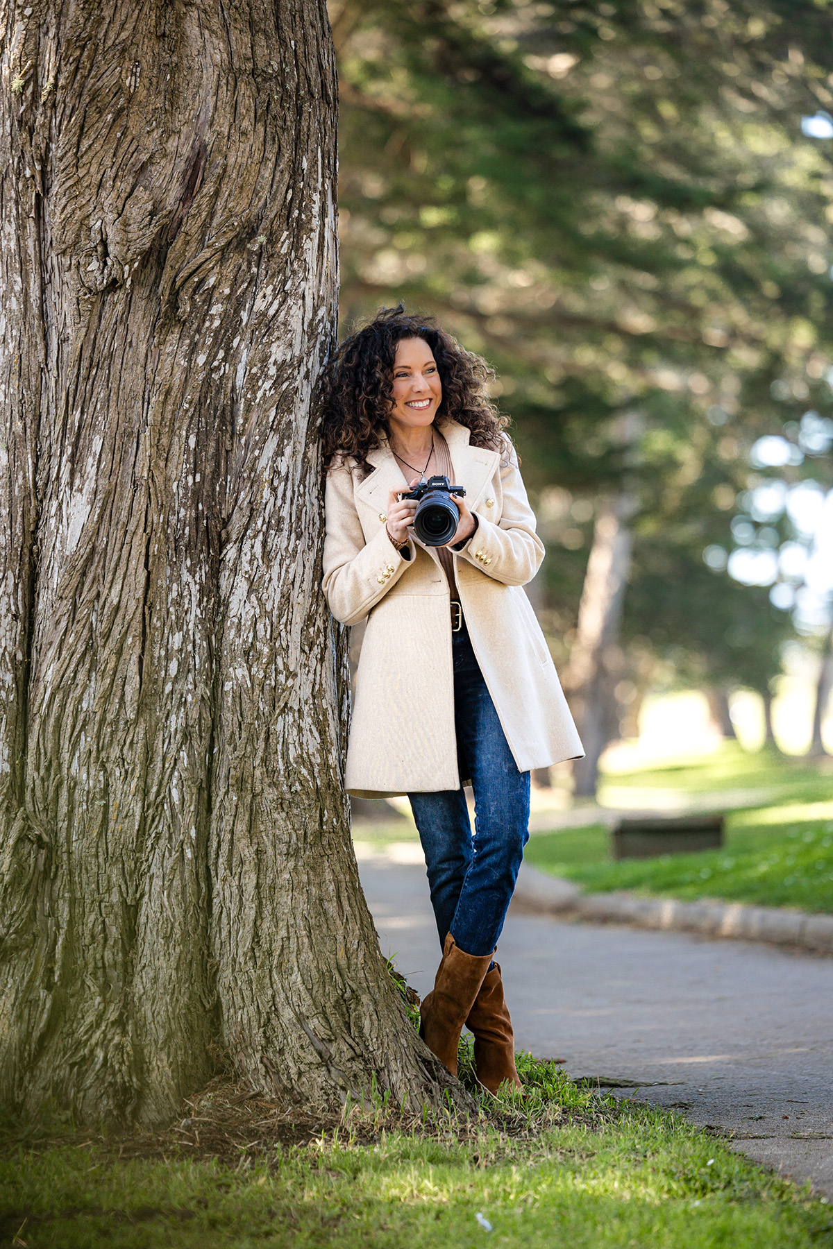 Rachel Levine San Francisco Wedding Planner and Photographer Leaning against a tree with her camera
