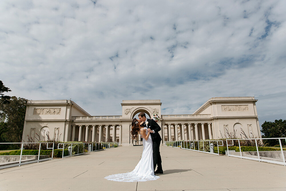 Outdoor photography near San Francisco City Hall Couple kissing in front of Legion of Honor