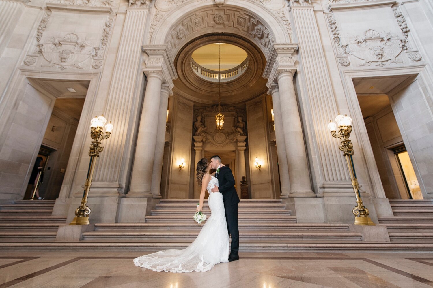 Bride and Groom Kissing Near San Francisco Grand Staircase