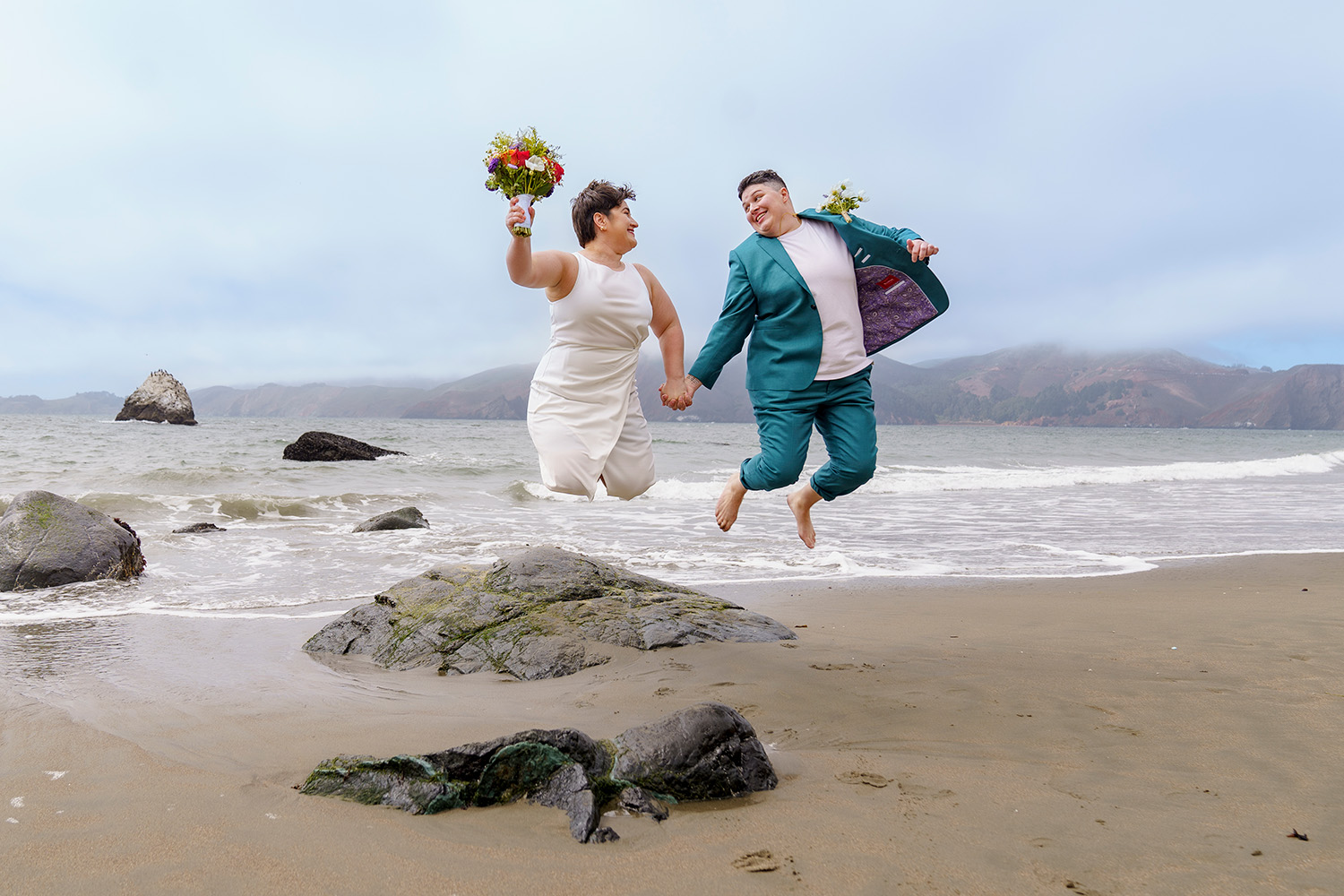 Same sex couple elopement portraits on Marshall Beach in San Francisco